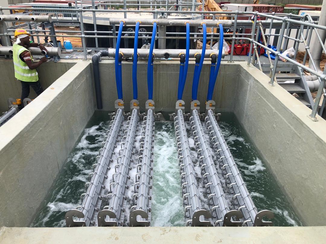 Engineer inspecting an aeration tank on an active construction site